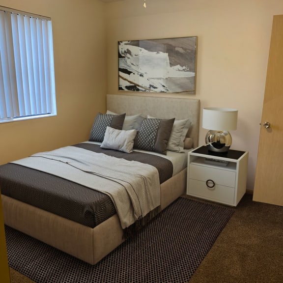 a bedroom with a bed and a nightstand