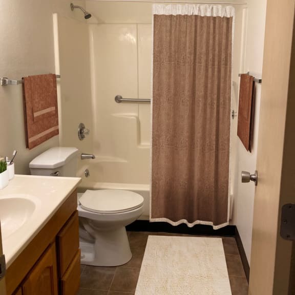 a bathroom with a toilet sink and shower