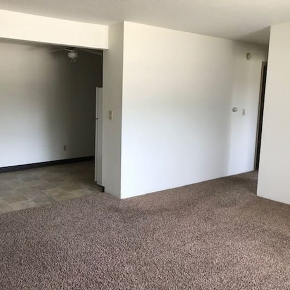 an empty room with a door that is open