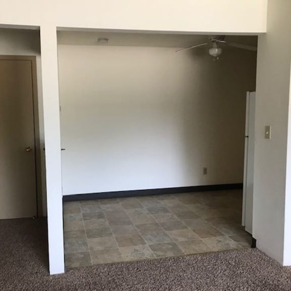 an empty room in a house with a tiled floor