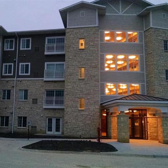 a large apartment building with a car parked in front of it