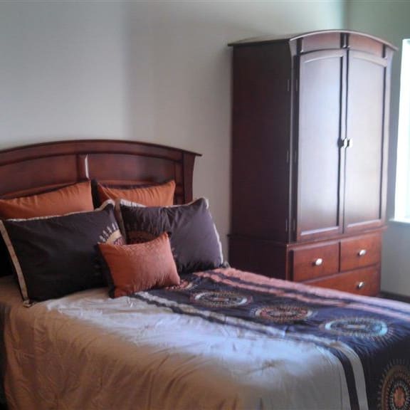 a bedroom with a bed and a dresser