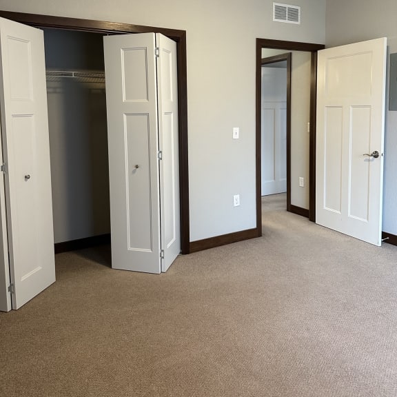 an overhead view of an empty closet with three drawers and a door