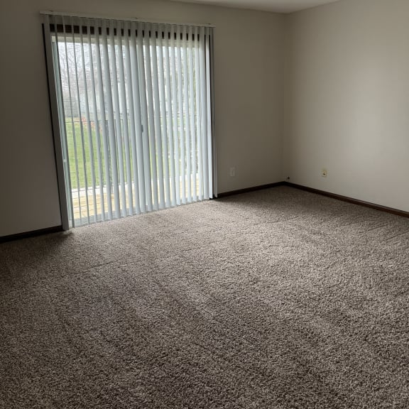 a window in a small room with a wall and a ceiling with a window