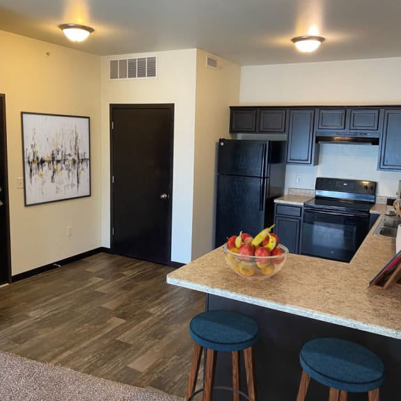 a view of the kitchen and living room in a one bedroom apartment at the staybridge suites