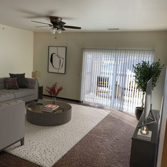 a living room with a ceiling fan and a sliding glass door