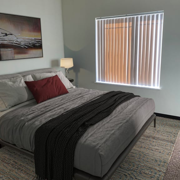 a bedroom with a bed and a window