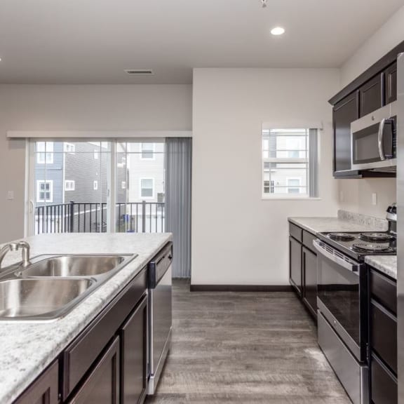 a kitchen with stainless steel appliances and granite counter tops