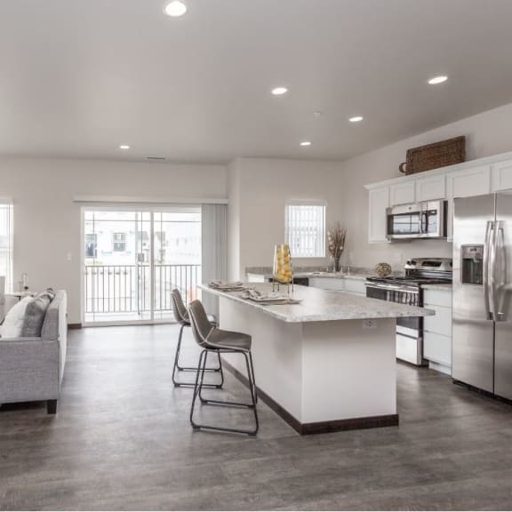 a kitchen and living room with an island and a white