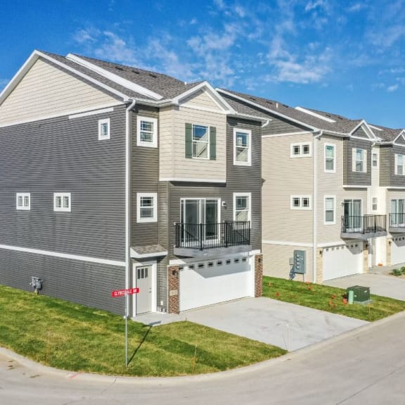 a row of condominiums on the side of a street