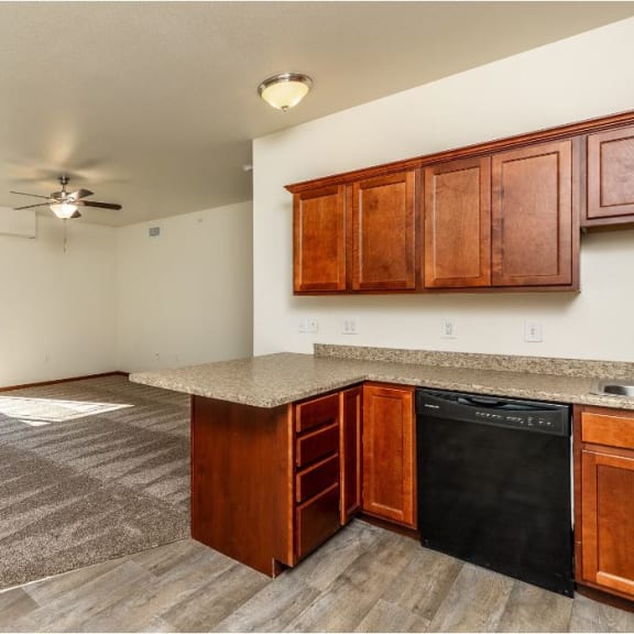 a kitchen and living room with a ceiling fan