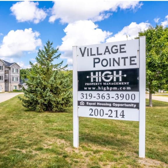 a village pointe high sign in front of an apartment building