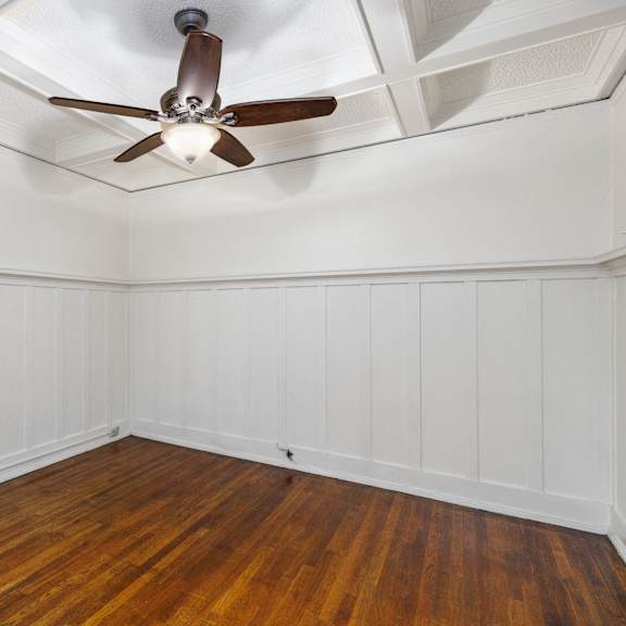 a room with a ceiling fan and wooden flooring at midtown apartments, portland, or, 97209