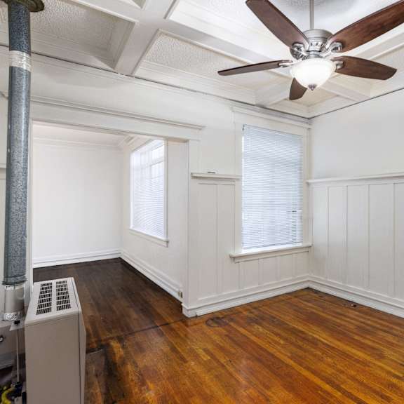 a room with a ceiling fan and a radiator on the floor at midtown  apartments, portland, or