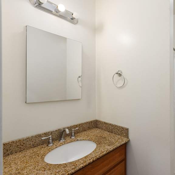 a bathroom with a sink, mirror, and shower at midtown apartments, portland, oregon