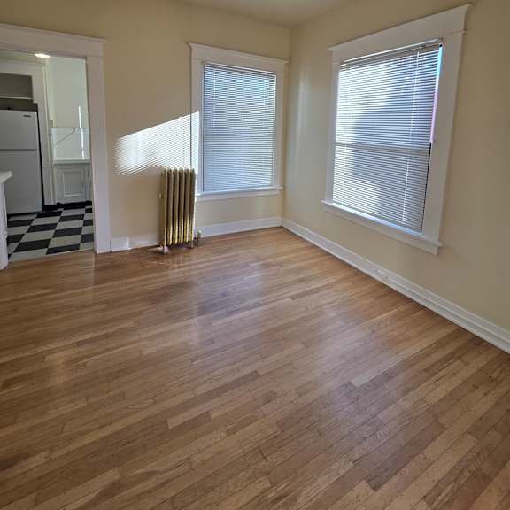 a wooden floor leads up to a window in a room with a white ceiling. at casa del rey apartments, apartments, portland, or