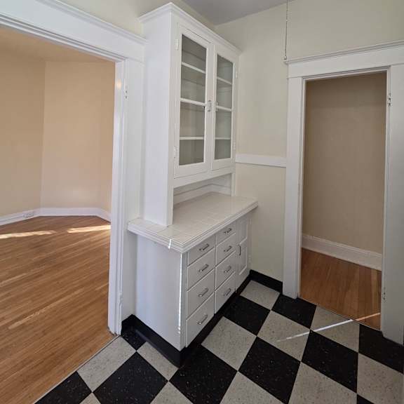 a white kitchen with a checkered floor at casa del rey apartments, apartments, portland, or
