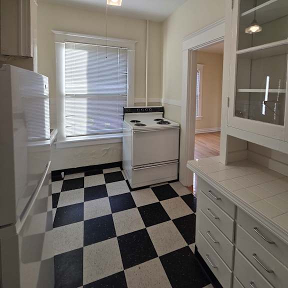 a black and white checkered floor in a kitchen. at casa del rey apartments, oregon