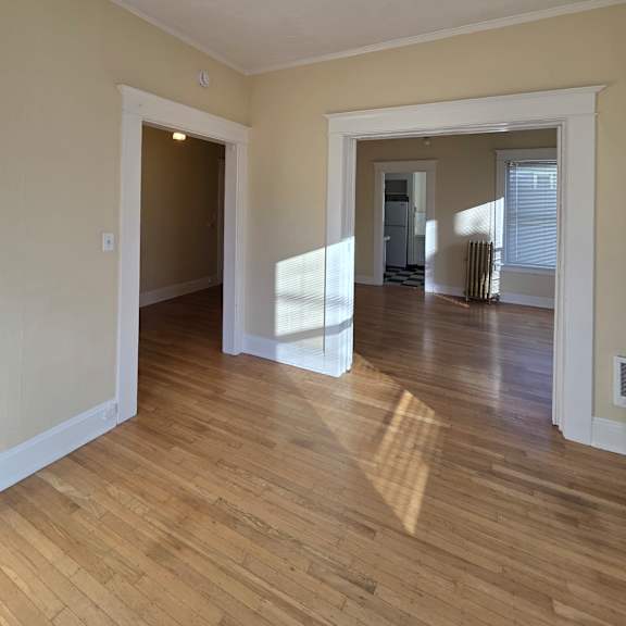 a white bathroom with a skylight and wooden walls. at casa del rey apartments, portland