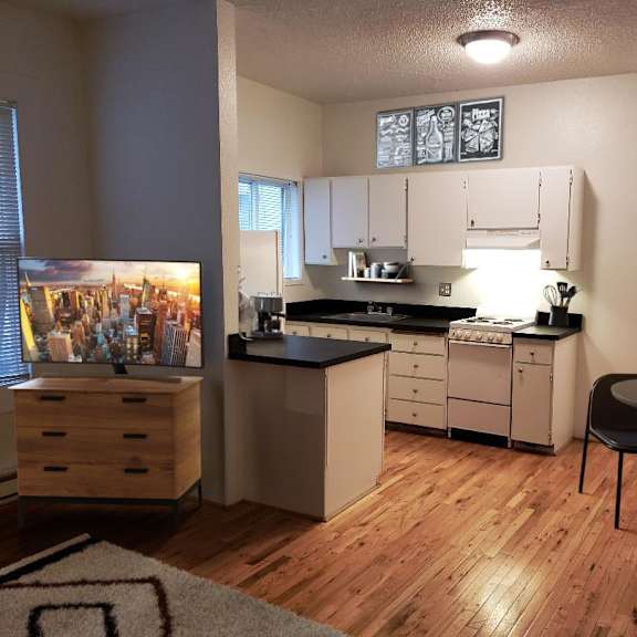 an open kitchen and dining area with a table and chairs