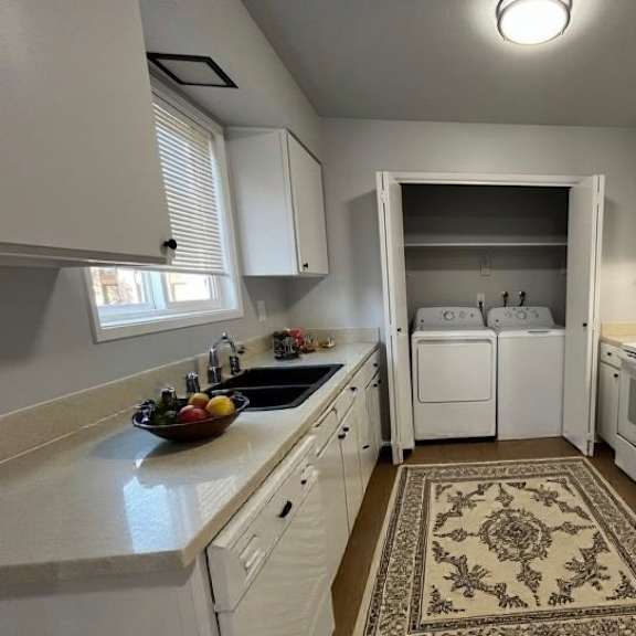 a kitchen with white appliances and cabinets.