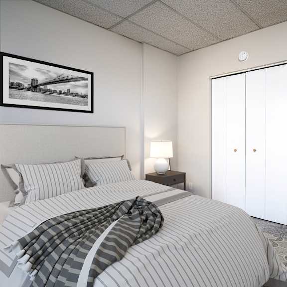 a bedroom with a bed, a lamp, a picture on the wall, and a plant.