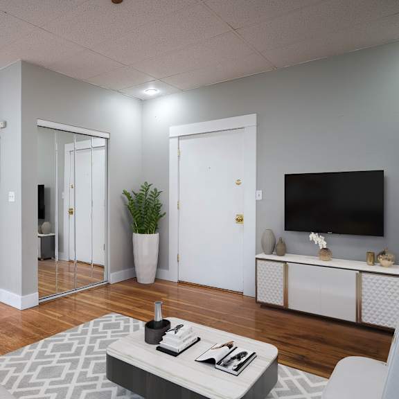 a modern living room with a grey sofa and a grey coffee table.