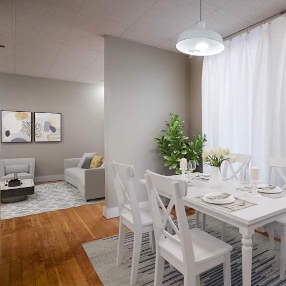 a dining room with a white table and chairs.