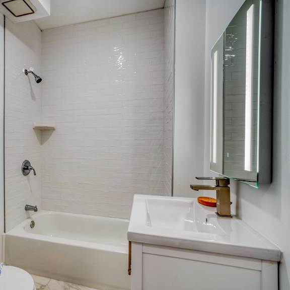 a white bathroom with a toilet, sink, and bathtub at clay & tiffany, portland, 97201