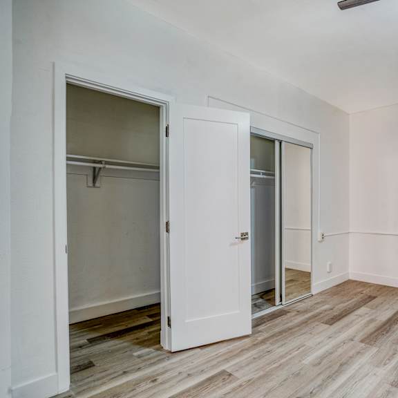 a room with a white door and a wooden floor at clay & tiffany, portland, 97201