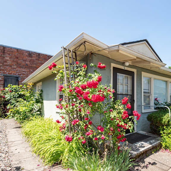 a house with a flower bed in front of it.