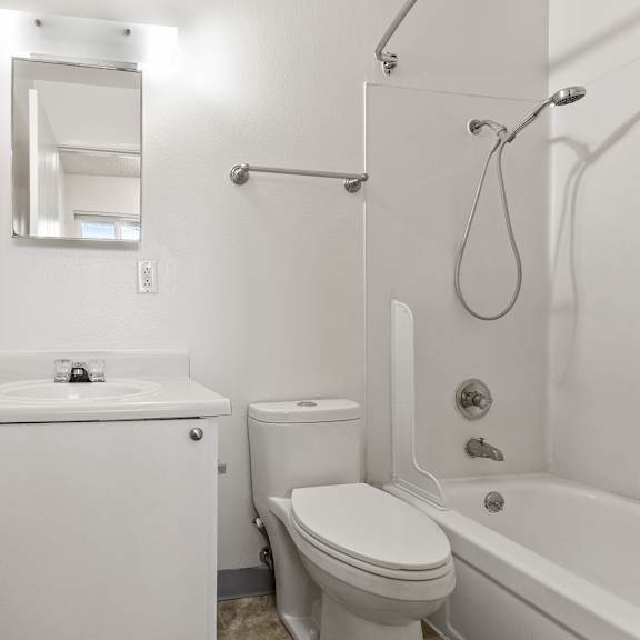 white bathroom with a toilet at garden villa apartments, portland, oregon