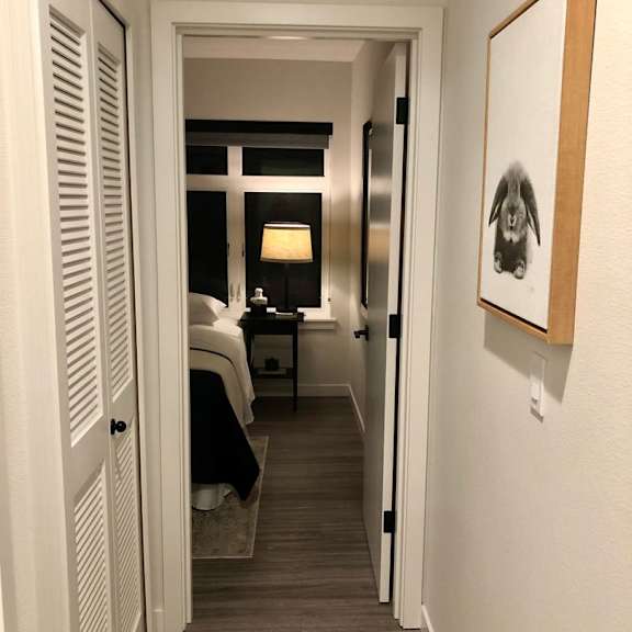 a hallway with a bedroom at the end.