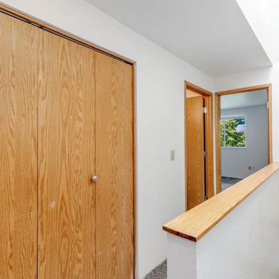 a wooden door with a mirror on the wall.at alder creek apartments, washington, 98682