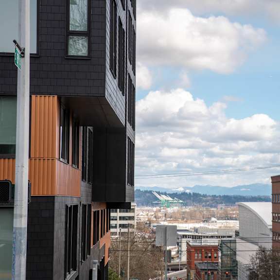 a view of the city and mountains from a building at analog tacoma, tacoma, 98402