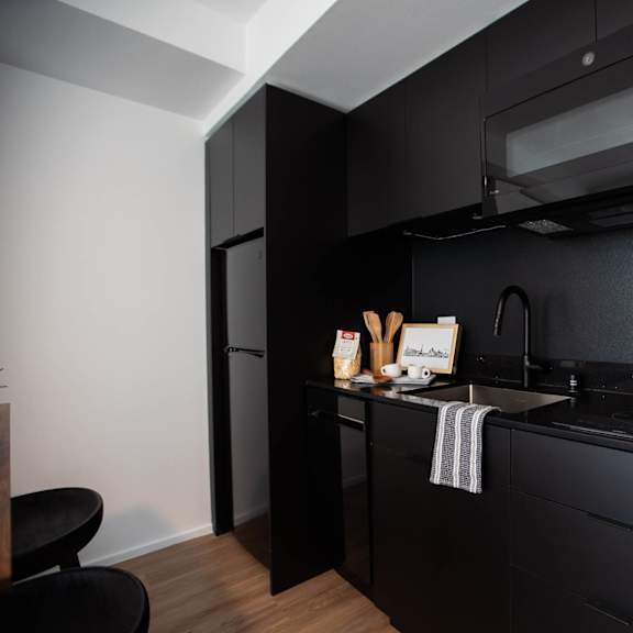 a small kitchen with a sink and a microwave at analog tacoma, washington