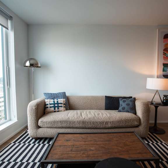 a living room with a couch and a large window at analog tacoma, tacoma, wa, 98402