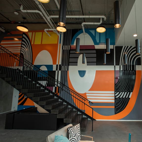 a mural in the lobby of a building with a staircase at analog tacoma, tacoma, 98402