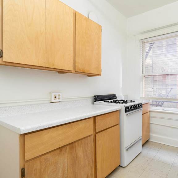 a kitchen with white appliances and wooden cabinets at clay & tiffany, portland, or, 97201