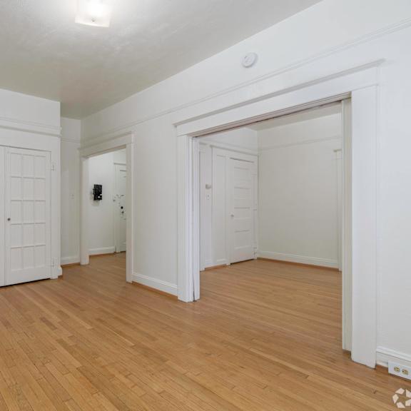 the living room and dining room with white doors and wood flooring at clay & tiffany, portland, 97201
