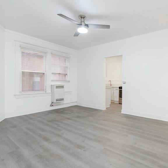 an empty living room with a ceiling fan and a window at clay & tiffany, portland, 97201