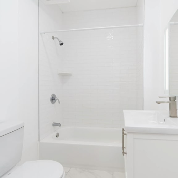 a white bathroom with a tub and a sink and a toilet at clay & tiffany, portland, or, 97201
