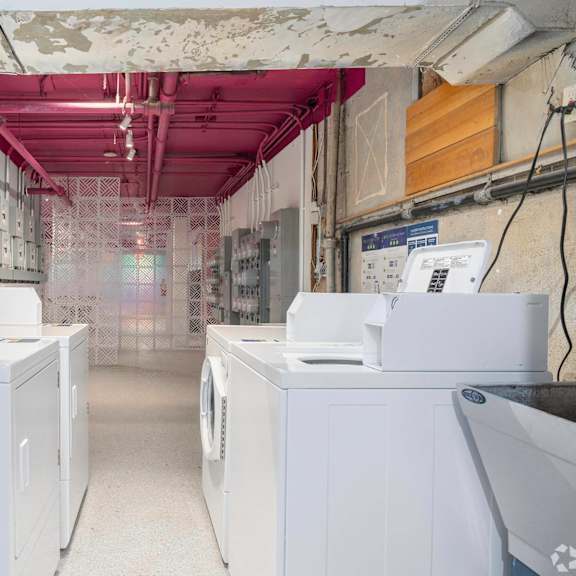 a laundry room with four washing machines in it at clay & tiffany, portland, 97201