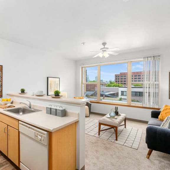 a kitchen with wooden cabinets and a white countertop.at fifth avenue place apartments, oregon