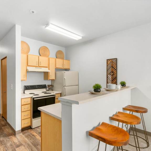 a kitchen with wooden floors and furniture.at fifth avenue place apartments, portland, 97209
