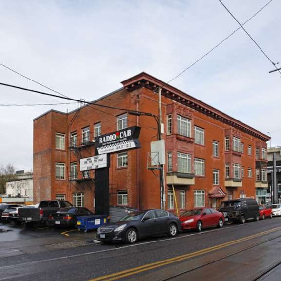 a red brick building with a sign that says radio cab. at midtown apartments, oregon