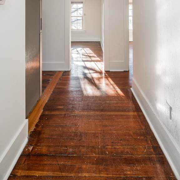 a long hallway with a wooden floor and white walls at midtown  apartments, portland, or