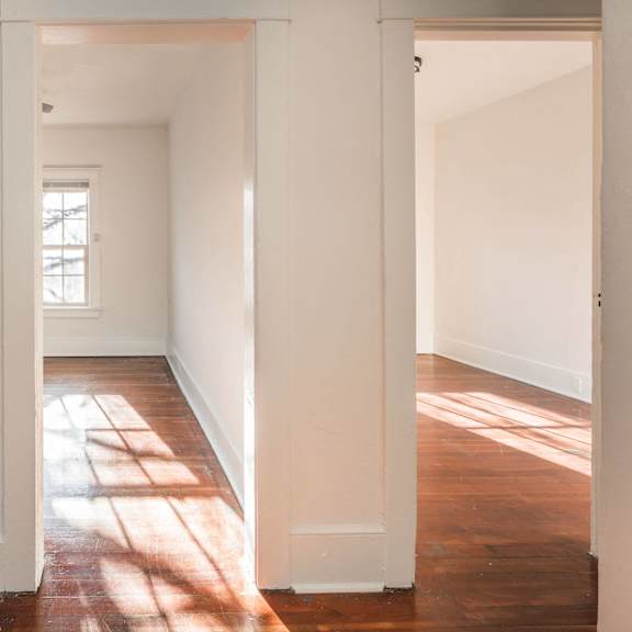 a white hallway with sunlight coming through the window at midtown apartments, oregon, 97209