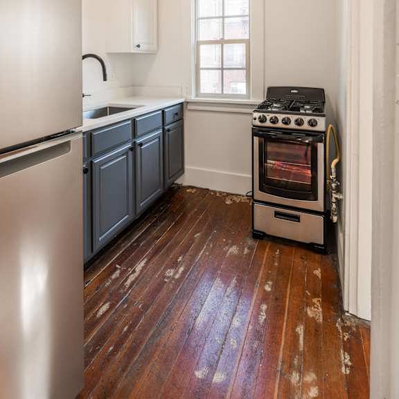 a kitchen with a stove and a refrigerator at midtown apartments, portland, oregon
