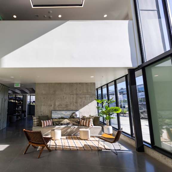 a living room with large windows and a table and chairs at moraine, tacoma, wa 98402